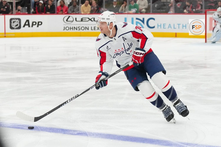 Nov 11, 2025; Raleigh, North Carolina, USA;  Washington Capitals defenseman John Carlson (74) skates with the puck against the Carolina Hurricanes during the first period at Lenovo Center. Credit: James Guillory-Imagn Images