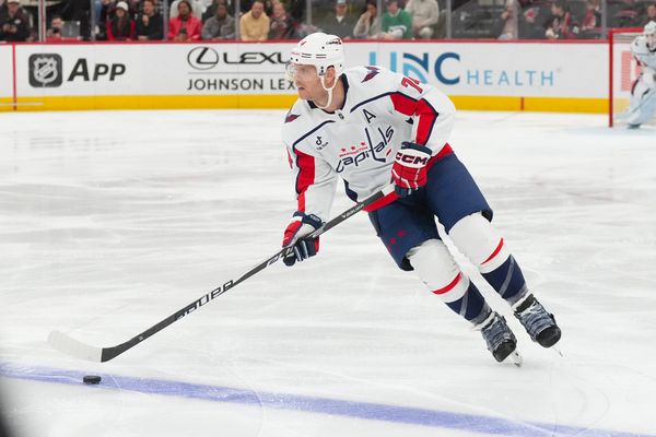 Nov 11, 2025; Raleigh, North Carolina, USA;  Washington Capitals defenseman John Carlson (74) skates with the puck against the Carolina Hurricanes during the first period at Lenovo Center. Mandatory Credit: James Guillory-Imagn Images