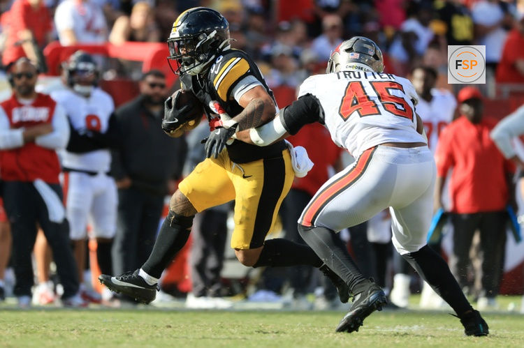 Oct 18, 2026; Tampa, Florida, USA;  Pittsburgh Steelers running back Jaylen Warren (30) rushes as Tampa Bay Buccaneers linebacker Josiah Trotter (45) tackles during overtime at Raymond James Stadium.  Credit: Kim Klement Neitzel-Imagn Images
