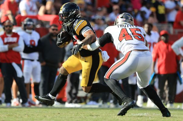 Oct 18, 2026; Tampa, Florida, USA;  Pittsburgh Steelers running back Jaylen Warren (30) rushes as Tampa Bay Buccaneers linebacker Josiah Trotter (45) tackles during overtime at Raymond James Stadium.  Mandatory Credit: Kim Klement Neitzel-Imagn Images