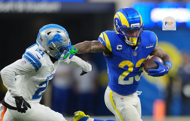 Dec 14, 2025; Inglewood, California, USA; Los Angeles Rams running back Kyren Williams (23) runs the ball against Detroit Lions cornerback Amik Robertson (21) during the fourth quarter at SoFi Stadium. Credit: Kirby Lee-Imagn Images