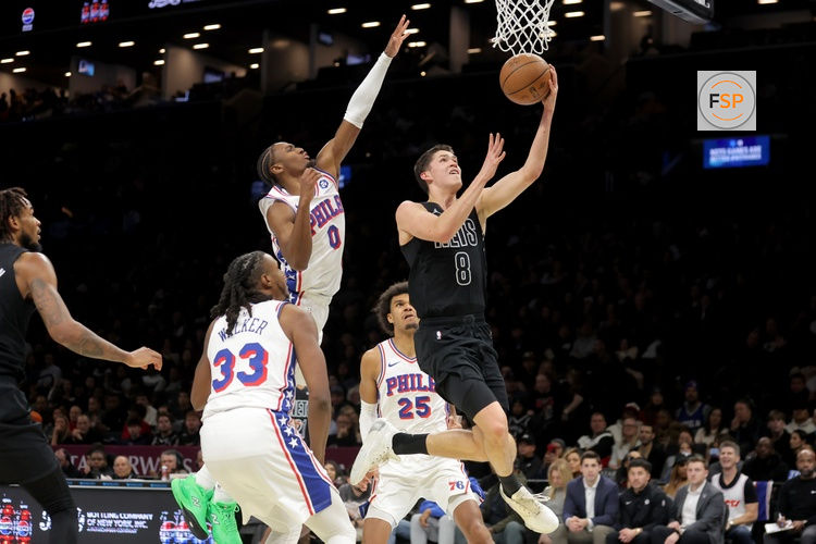 Nov 28, 2025; Brooklyn, New York, USA; Brooklyn Nets guard Egor Demin (8) drives to the basket against Philadelphia 76ers forward Jabari Walker (33) and guard Tyrese Maxey (0) and forward Dominick Barlow (25) during the third quarter at Barclays Center. Credit: Brad Penner-Imagn Images