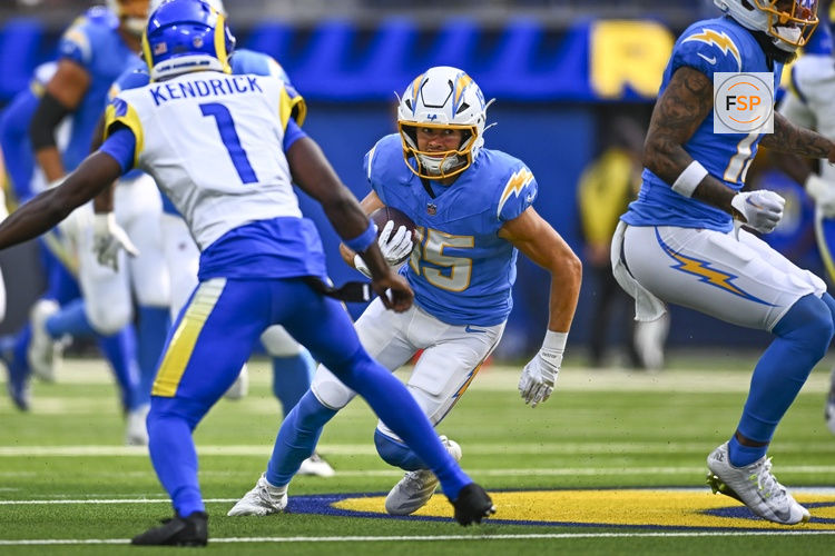 Aug 16, 2025; Inglewood, California, USA; Los Angeles Chargers wide receiver Ladd McConkey (15) runs the ball against Los Angeles Rams cornerback Derion Kendrick (1) during the first quarter at SoFi Stadium. Credit: Jonathan Hui-Imagn Images