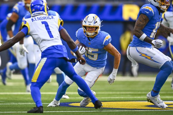 Aug 16, 2025; Inglewood, California, USA; Los Angeles Chargers wide receiver Ladd McConkey (15) runs the ball against Los Angeles Rams cornerback Derion Kendrick (1) during the first quarter at SoFi Stadium. Mandatory Credit: Jonathan Hui-Imagn Images