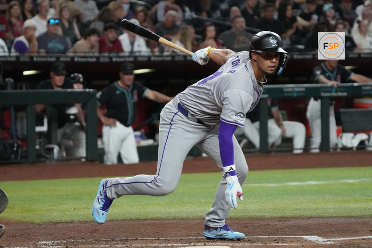 Aug 12, 2024; Phoenix, Arizona, USA; Colorado Rockies shortstop Ezequiel Tovar (14) reacts after lunging at a ball aginst the Arizona Diamondbacks in the first inning at Chase Field. Credit: Rick Scuteri-USA TODAY Sports