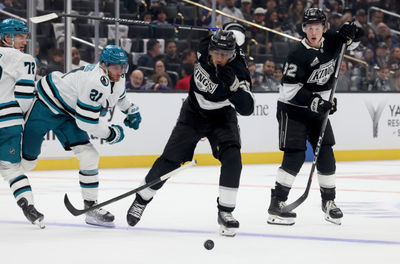 Oct 24, 2024; Los Angeles, California, USA; Los Angeles Kings right wing Quinton Byfield (55) knocks the stick away from San Jose Sharks center Alexander Wennberg (21) in front of Los Angeles Kings defenseman Brandt Clarke (92) during the second period at Crypto.com Arena. Mandatory Credit: Jason Parkhurst-Imagn Images