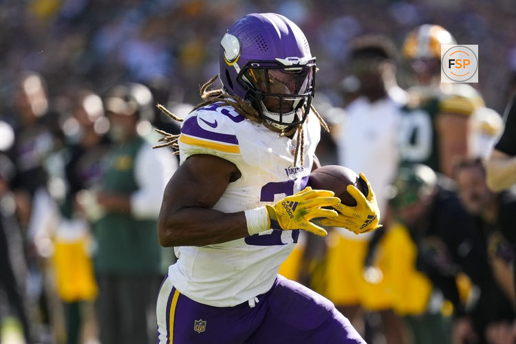 Sep 29, 2024; Green Bay, Wisconsin, USA;  Minnesota Vikings running back Aaron Jones (33) rushes with the football during the fourth quarter against the Green Bay Packers at Lambeau Field. Credit: Jeff Hanisch-Imagn Images