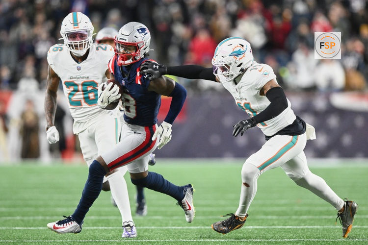 Jan 4, 2026; Foxborough, Massachusetts, USA; New England Patriots wide receiver Stefon Diggs (8) runs after the catch against Miami Dolphins safety Dante Trader Jr. (11) and cornerback Rasul Douglas (26) during the fourth quarter at Gillette Stadium. Credit: Brian Fluharty-Imagn Images