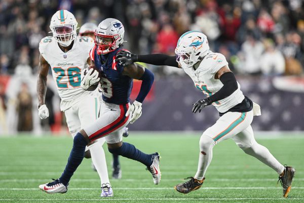 Jan 4, 2026; Foxborough, Massachusetts, USA; New England Patriots wide receiver Stefon Diggs (8) runs after the catch against Miami Dolphins safety Dante Trader Jr. (11) and cornerback Rasul Douglas (26) during the fourth quarter at Gillette Stadium. Mandatory Credit: Brian Fluharty-Imagn Images