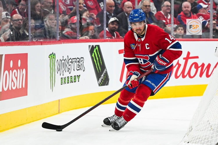 Oct 20, 2026; Montreal, Quebec, CAN; Montreal Canadiens center Nick Suzuki (14) plays the puck against the San Jose Sharks during the second period at Bell Centre. Credit: David Kirouac-Imagn Images
