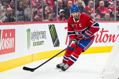 Oct 20, 2026; Montreal, Quebec, CAN; Montreal Canadiens center Nick Suzuki (14) plays the puck against the San Jose Sharks during the second period at Bell Centre. Mandatory Credit: David Kirouac-Imagn Images