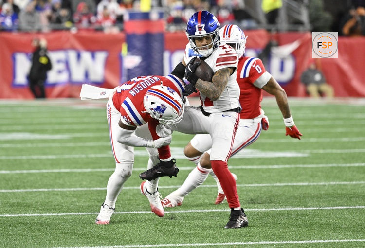 Dec 1, 2025; Foxborough, Massachusetts, USA; New York Giants wide receiver Wan'Dale Robinson (17) runs with the ball against New England Patriots safety Craig Woodson (31) during the third quarter at Gillette Stadium. Credit: Eric Canha-Imagn Images