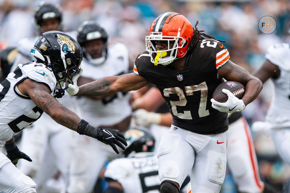 Sep 15, 2024; Jacksonville, Florida, USA; Cleveland Browns running back D'Onta Foreman (27) stiff arms Jacksonville Jaguars safety Antonio Johnson (26) in the fourth quarter  at EverBank Stadium. Credit: Jeremy Reper-Imagn Images