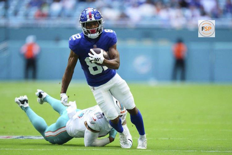 Aug 22, 2026; Miami Gardens, Florida, USA;  New York Giants wide receiver Calvin Austin III (82) breaks the tackle of Miami Dolphins linebacker Jacob Rodriguez (10) during the first quarter of a preseason game at Hard Rock Stadium.  Credit: Rich Storry-Imagn Images