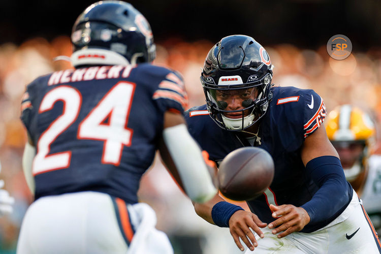 CHICAGO, IL - SEPTEMBER 10: Chicago Bears quarterback Justin Fields (1) flips the ball to running back Khalil Herbert (24) in the third quarter during a regular season game between the Green Bay Packers and the Chicago Bears on September, 10, 2023, at Soldier Field in Chicago, IL. (Photo by Brandon Sloter/Icon Sportswire)