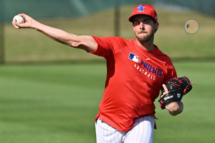 Feb 12, 2025; Clearwater, FL, USA;  Philadelphia Phillies pitcher Aaron Nola (27) warms up during a spring training workout at Carpenter Complex. Credit: Jonathan Dyer-Imagn Images