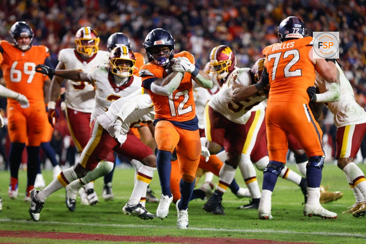 Nov 30, 2025; Landover, Maryland, USA; Denver Broncos running back RJ Harvey (12) scores a touchdown against the Washington Commanders in overtime of the game at Northwest Stadium. Credit: Peter Casey-Imagn Images