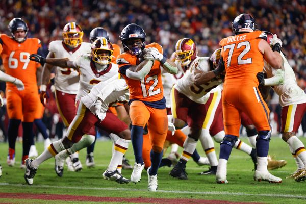 Nov 30, 2025; Landover, Maryland, USA; Denver Broncos running back RJ Harvey (12) scores a touchdown against the Washington Commanders in overtime of the game at Northwest Stadium. Mandatory Credit: Peter Casey-Imagn Images