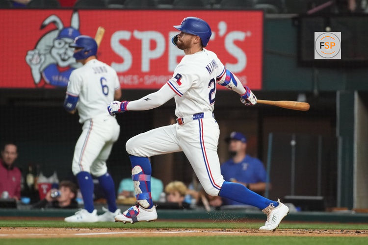 May 26, 2026; Arlington, Texas, USA; Texas Rangers right fielder Brandon Nimmo (24) hits a single against the Houston Astros during the first inning at Globe Life Field. Credit: Raymond Carlin III-Imagn Images