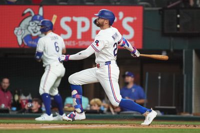 May 26, 2026; Arlington, Texas, USA; Texas Rangers right fielder Brandon Nimmo (24) hits a single against the Houston Astros during the first inning at Globe Life Field. Mandatory Credit: Raymond Carlin III-Imagn Images