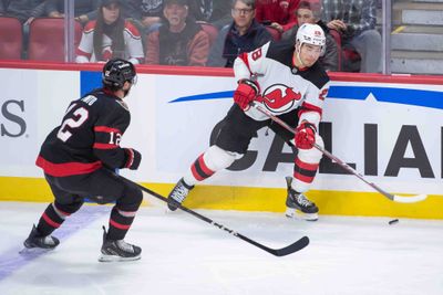 Oct 17, 2024; Ottawa, Ontario, CAN; New Jersey Devils right Timo Meier (28) moves the puck away from Ottawa Senators center Shane Pinto (12) in the third period at the Canadian Tire Centre. Mandatory Credit: Marc DesRosiers-Imagn Images