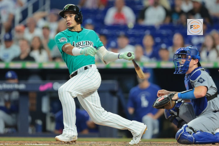 Sep 13, 2026; Miami, Florida, USA; Miami Marlins third baseman Javier Sanoja (8) hits a two-run double against the Los Angeles Dodgers during the ninth inning at loanDepot Park. Credit: Sam Navarro-Imagn Images