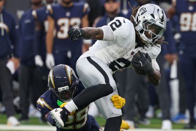 Nov 30, 2025; Inglewood, California, USA; Las Vegas Raiders running back Ashton Jeanty (2) rushes the ball past Los Angeles Chargers cornerback Tarheeb Still (29) during the second half at SoFi Stadium. Mandatory Credit: Kiyoshi Mio-Imagn Images