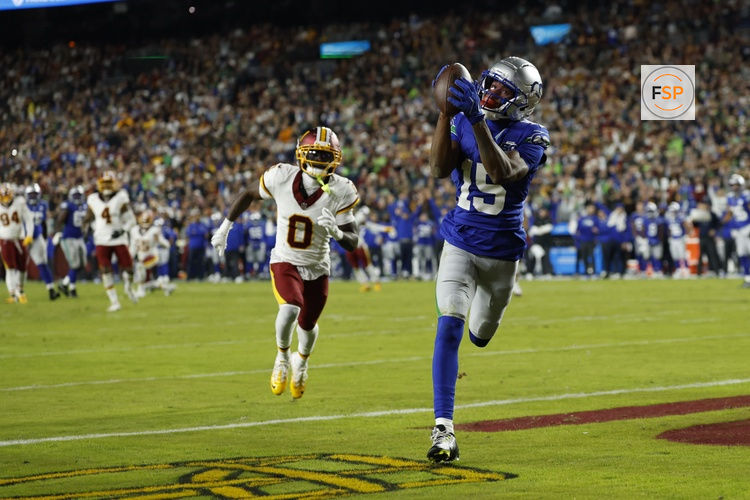 Nov 2, 2025; Landover, Maryland, USA;  Seattle Seahawks wide receiver Tory Horton (15) catches a touchdown pass as Washington Commanders cornerback Mike Sainristil (0) watches during the second quarter at Northwest Stadium. Credit: Geoff Burke-Imagn Images