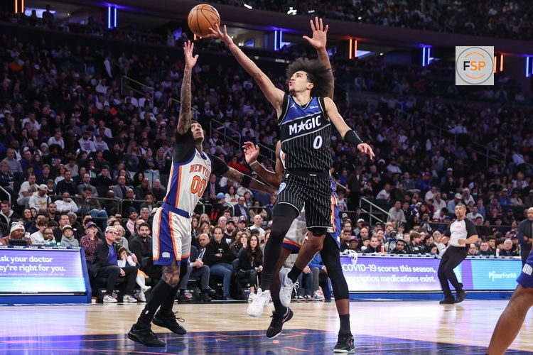 Dec 7, 2025; New York, New York, USA;  Orlando Magic guard Anthony Black (0) drives past New York Knicks guard Jordan Clarkson (00) in the fourth quarter at Madison Square Garden. Credit: Wendell Cruz-Imagn Images