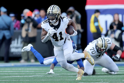 Dec 8, 2024; East Rutherford, New Jersey, USA; New Orleans Saints running back Alvin Kamara (41) runs with the ball against the New York Giants during the second quarter at MetLife Stadium. Mandatory Credit: Brad Penner-Imagn Images