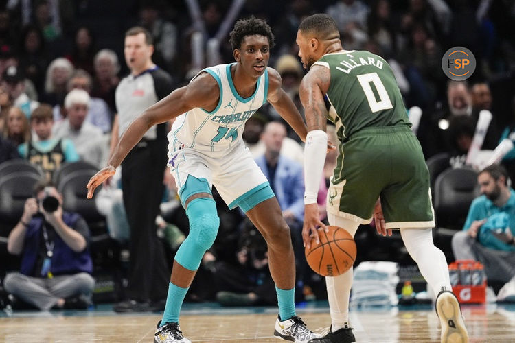 Feb 5, 2025; Charlotte, North Carolina, USA; Charlotte Hornets forward Moussa Diabate (14) on defense against Milwaukee Bucks guard Damian Lillard (0) during the second half at Spectrum Center. Credit: Jim Dedmon-Imagn Images