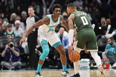 Feb 5, 2025; Charlotte, North Carolina, USA; Charlotte Hornets forward Moussa Diabate (14) on defense against Milwaukee Bucks guard Damian Lillard (0) during the second half at Spectrum Center. Mandatory Credit: Jim Dedmon-Imagn Images