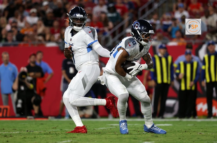 Aug 9, 2025; Tampa, Florida, USA; Tennessee Titans quarterback Cameron Ward (1) hands the ball off to Tennessee Titans running back Tony Pollard (20) against the Tampa Bay Buccaneers during the first half at Raymond James Stadium. Credit: Kim Klement Neitzel-Imagn Images