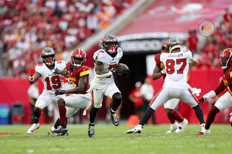 Sep 8, 2024; Tampa, Florida, USA; Tampa Bay Buccaneers running back Bucky Irving (7) runs with the ball against the Washington Commanders in the fourth quarter at Raymond James Stadium. Credit: Nathan Ray Seebeck-Imagn Images