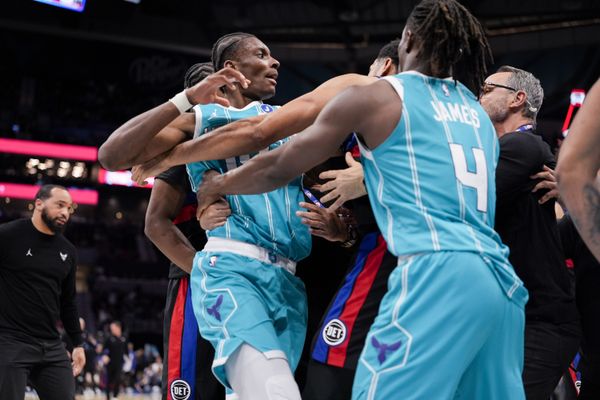 Feb 9, 2026; Charlotte, North Carolina, USA;  Charlotte Hornets forward Moussa Diabaté (14) is held back by guard Sion James (4) engaging with Detroit Pistons forward Tobias Harris (12) during the second half at Spectrum Center. Mandatory Credit: Jim Dedmon-Imagn Images