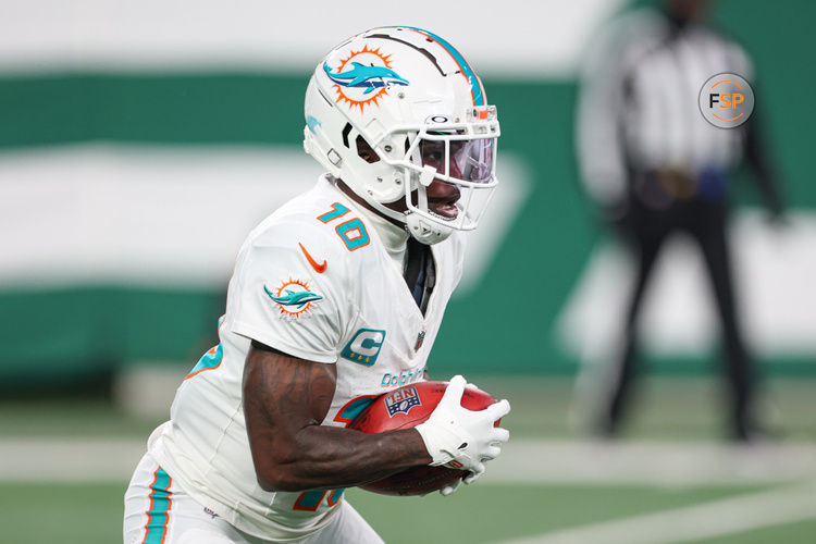 Jan 5, 2025; East Rutherford, New Jersey, USA; Miami Dolphins wide receiver Tyreek Hill (10) returns punt during the first half against the New York Jets at MetLife Stadium. Credit: Vincent Carchietta-Imagn Images