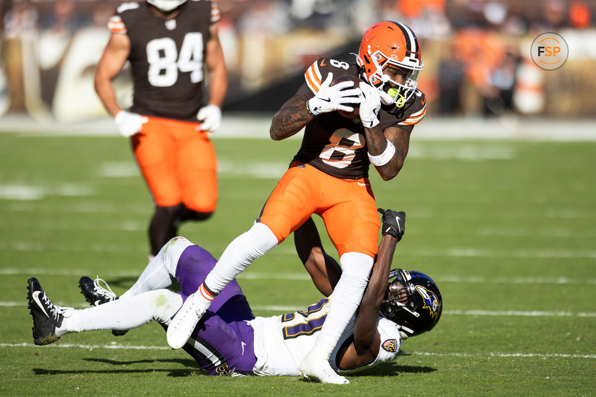 Oct 27, 2024; Cleveland, Ohio, USA; Cleveland Browns wide receiver Elijah Moore (8) makes a catch for a first down under coverage by Baltimore Ravens cornerback Brandon Stephens (21) during the fourth quarter at Huntington Bank Field. Credit: Scott Galvin-Imagn Images