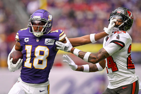 MINNEAPOLIS, MN - SEPTEMBER 10: Minnesota Vikings wide receiver Justin Jefferson (18) stiff-arms Tampa Bay Buccaneers defensive back Carlton Davis (24) during the second quarter of an NFL game between the Minnesota Vikings and Tampa Bay Buccaneers  on September 10, 2023, at U.S. Bank Stadium in Minneapolis, MN. (Photo by Nick Wosika/Icon Sportswire)