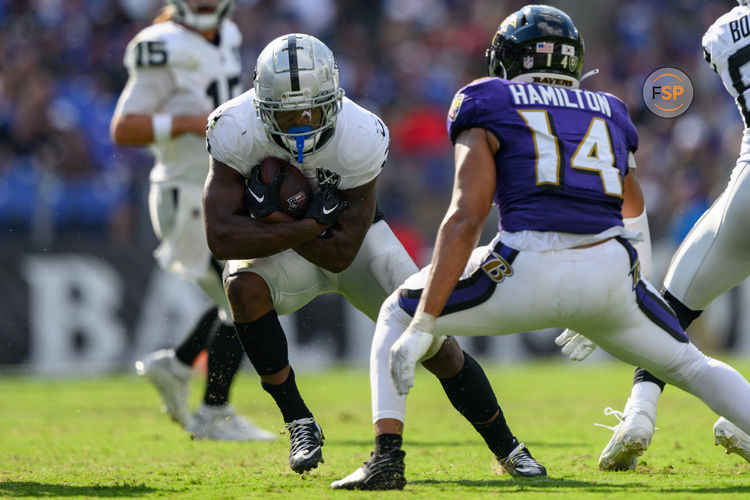 Sep 15, 2024; Baltimore, Maryland, USA; Las Vegas Raiders running back Zamir White (3) runs the ball as Baltimore Ravens safety Kyle Hamilton (14) defends during the second half at M&T Bank Stadium. Credit: Reggie Hildred-Imagn Images