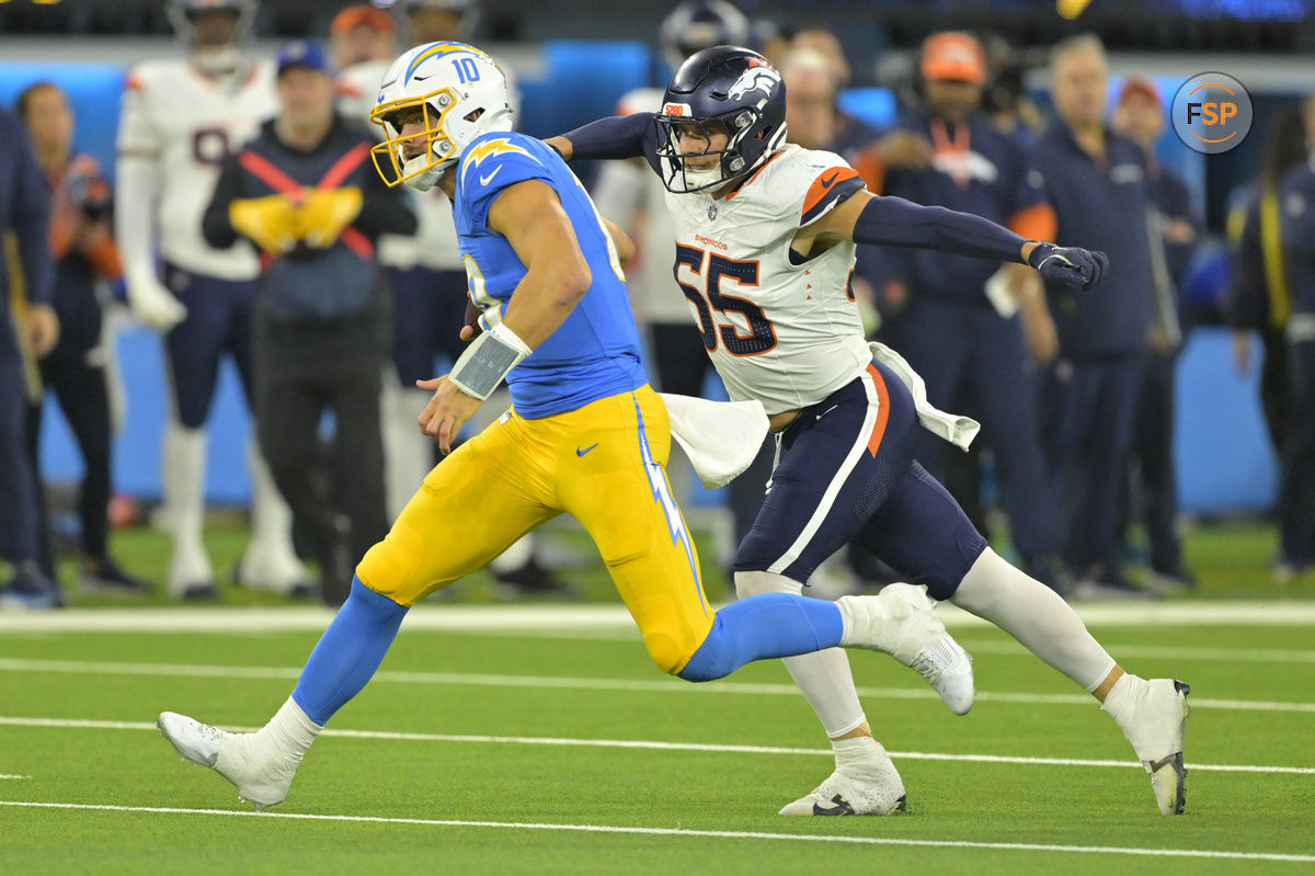 Dec 19, 2024; Inglewood, California, USA;  Los Angeles Chargers quarterback Justin Herbert (10) is brought down by Denver Broncos linebacker Cody Barton (55) after an 18-yard run in the second half at SoFi Stadium. Credit: Jayne Kamin-Oncea-Imagn Images