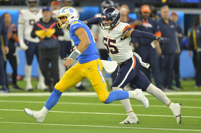 Dec 19, 2024; Inglewood, California, USA;  Los Angeles Chargers quarterback Justin Herbert (10) is brought down by Denver Broncos linebacker Cody Barton (55) after an 18-yard run in the second half at SoFi Stadium. Mandatory Credit: Jayne Kamin-Oncea-Imagn Images