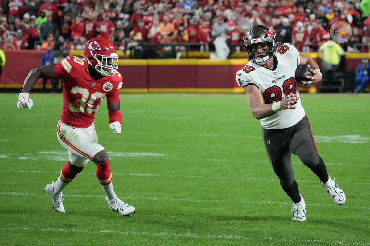 Nov 4, 2024; Kansas City, Missouri, USA; Tampa Bay Buccaneers tight end Cade Otton (88) runs the ball as Kansas City Chiefs cornerback Christian Roland-Wallace (30) chases during the second half at GEHA Field at Arrowhead Stadium. Credit: Denny Medley-Imagn Images