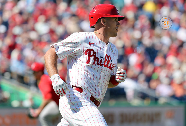 Feb 28, 2025; Clearwater, Florida, USA;  Philadelphia Phillies catcher J.T. Realmuto (10) hits a RBI single against the Boston Red Sox during the third inning at BayCare Ballpark. Credit: Kim Klement Neitzel-Imagn Images