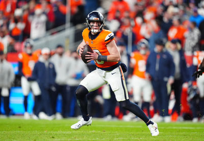 Dec 15, 2024; Denver, Colorado, USA; Denver Broncos quarterback Bo Nix (10) scrambles with the ball in the fourth quarter against the Indianapolis Colts at Empower Field at Mile High. Mandatory Credit: Ron Chenoy-Imagn Images