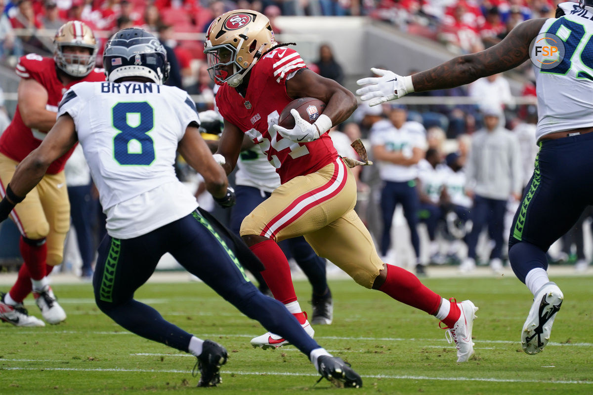 Nov 17, 2024; Santa Clara, California, USA; San Francisco 49ers running back Jordan Mason (24) rushes the ball whlie being pursued by Seattle Seahawks cornerback Coby Bryant (8) in the first quarter at Levi's Stadium. Credit: David Gonzales-Imagn Images