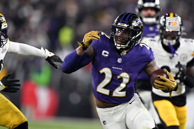 Jan 11, 2025; Baltimore, Maryland, USA; Baltimore Ravens running back Derrick Henry (22) runs against Pittsburgh Steelers linebacker Elandon Roberts (50) in the second quarter in an AFC wild card game at M&T Bank Stadium. Credit: Tommy Gilligan-Imagn Images