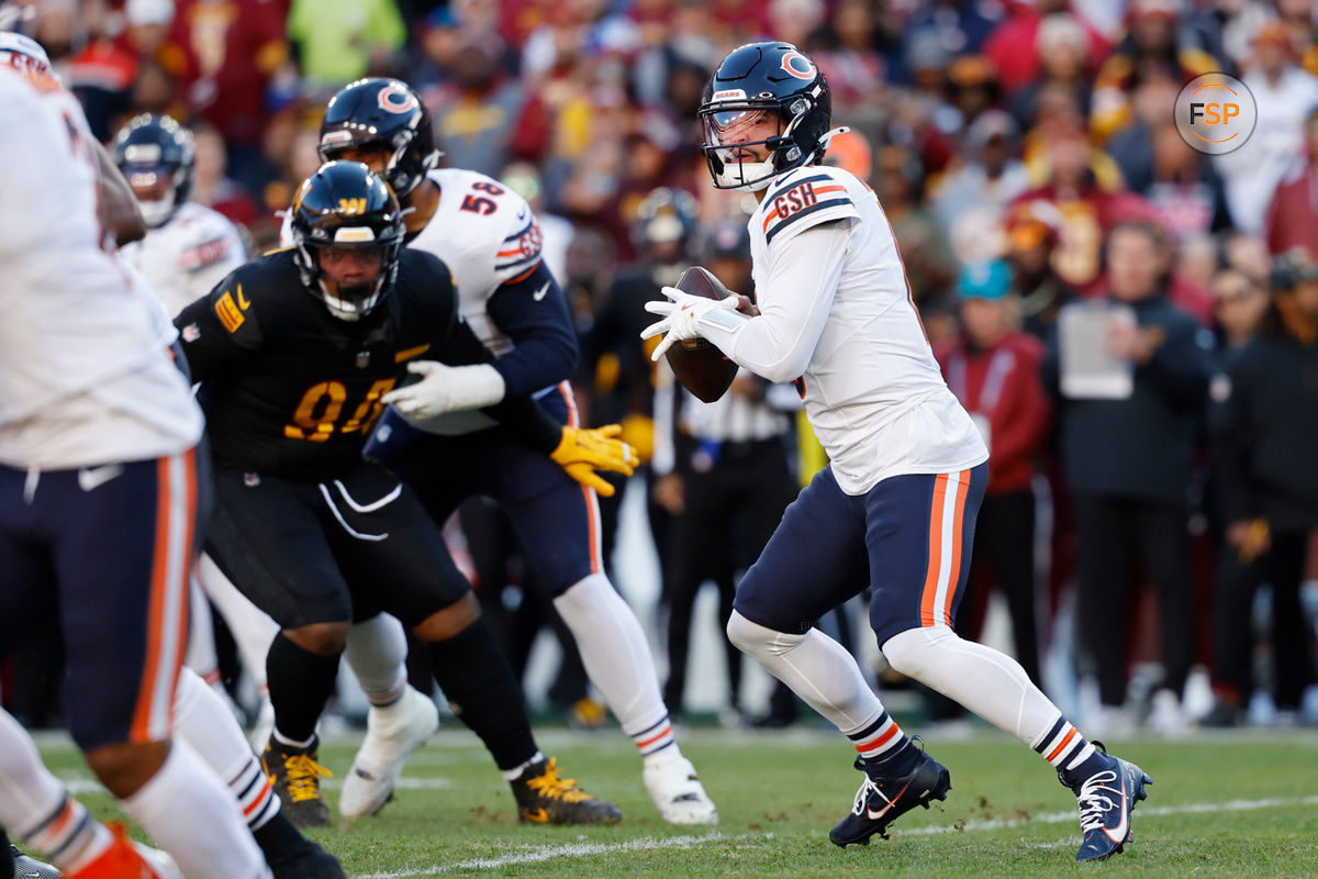 Oct 27, 2024; Landover, Maryland, USA; Chicago Bears quarterback Caleb Williams (18) prepares to pass the ball as Washington Commanders defensive tackle Daron Payne (94) chases during the first quarter at Northwest Stadium. Credit: Geoff Burke-Imagn Images