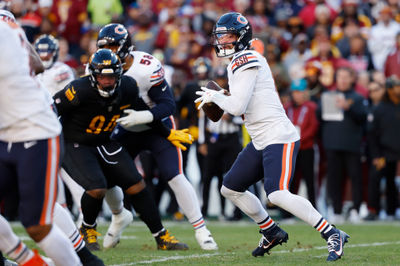 Oct 27, 2024; Landover, Maryland, USA; Chicago Bears quarterback Caleb Williams (18) prepares to pass the ball as Washington Commanders defensive tackle Daron Payne (94) chases during the first quarter at Northwest Stadium. Mandatory Credit: Geoff Burke-Imagn Images