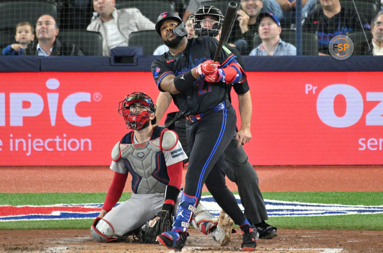 Sep 25, 2024; Toronto, Ontario, CAN;  Toronto Blue Jays first baseman Vladimir Guerrero Jr. (27) hits a double against the Boston Red Sox in the fourth inning at Rogers Centre. Credit: Dan Hamilton-Imagn Images