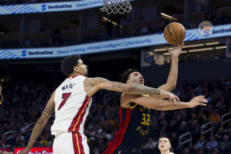 Jan 7, 2025; San Francisco, California, USA;  Miami Heat center Kel'el Ware (7) fouls Golden State Warriors forward Trayce Jackson-Davis (32) during the third quarter at Chase Center. Credit: John Hefti-Imagn Images